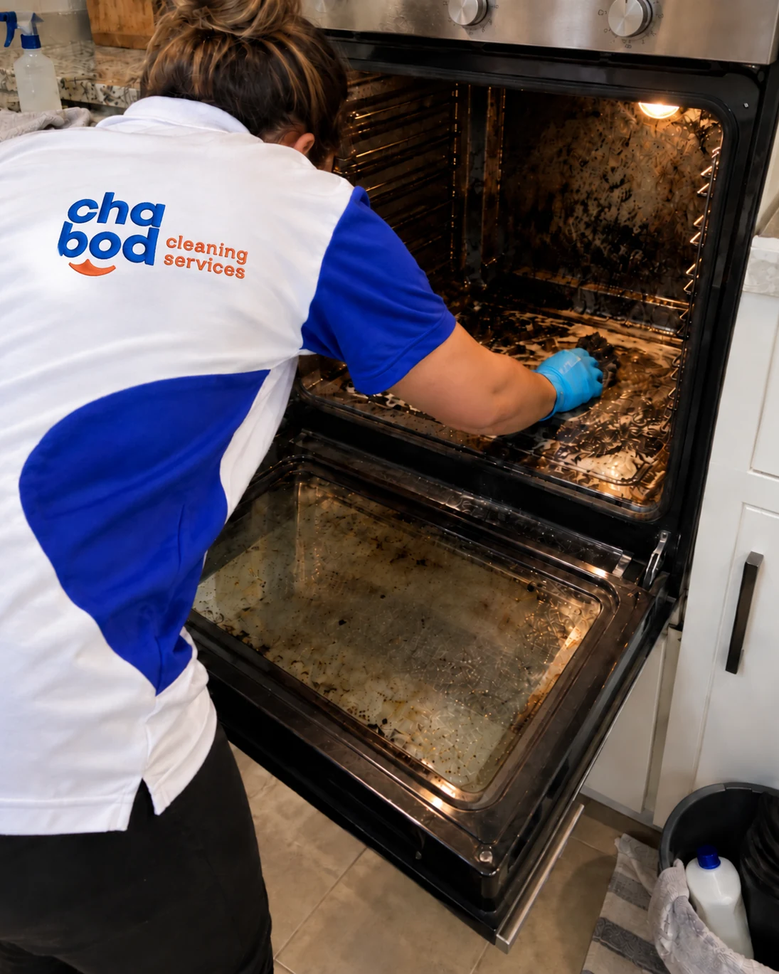 Chabod Cleaning Services team member deep cleaning inside a heavily soiled oven in San Antonio