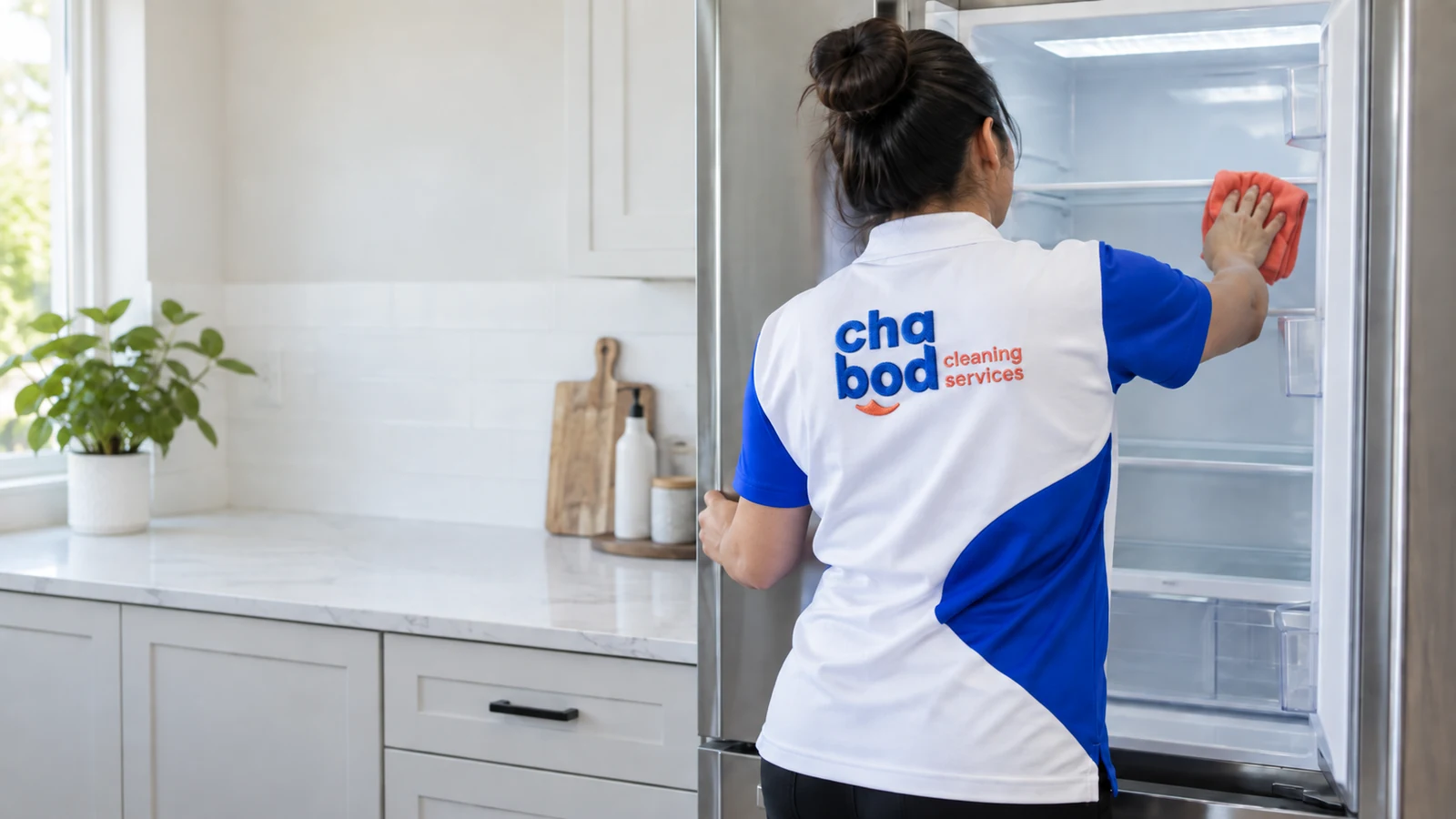 Chabod Cleaning Services team member cleaning inside a refrigerator in a San Antonio home